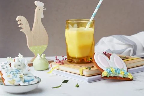 Easter table setting. Milk glass and decorated Easter cookies among table Stock Photos