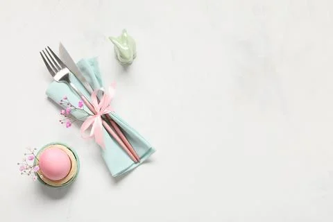 Easter table setting with painted egg, gypsophila flowers and ceramic rabbit  Stock Photos