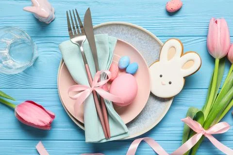 Easter table setting with painted eggs, tulip flowers, cookie and ceramic rab Stock Photos