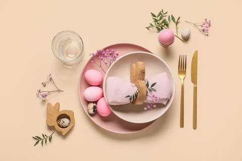 Easter table setting with painted eggs, gypsophila flowers and olive branches Stock Photos