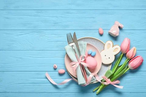 Easter table setting with painted eggs, tulip flowers, cookie and ceramic rab Stock Photos