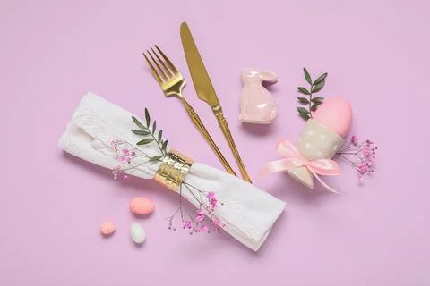 Easter table setting with painted eggs, gypsophila flowers, ceramic rabbit an Stock Photos