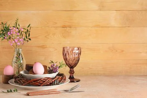 Easter table setting with painted eggs, gypsophila flowers, olive branches an Stock Photos