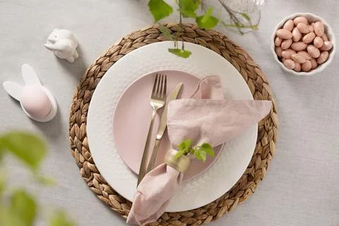 Easter table setting with pink plate and spring decor Stock Photos