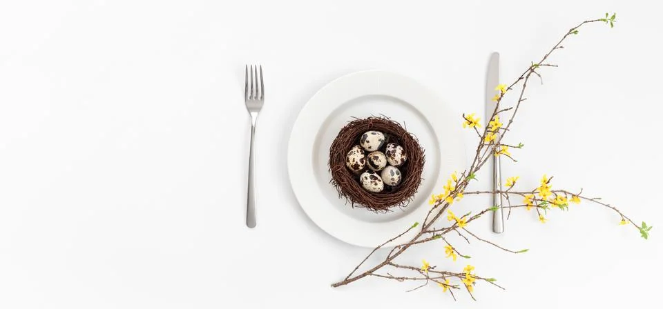 Easter table setting with quail eggs in a nest  Stock Photos