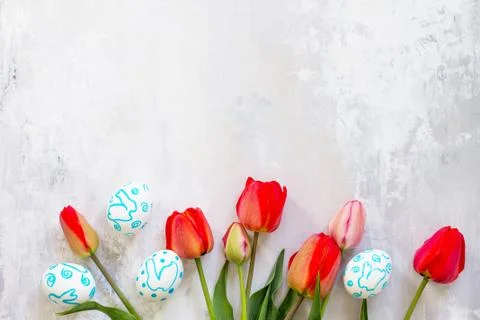 Easter table setting with tulips flowers and Easter eggs. Holidays background. Stock Photos
