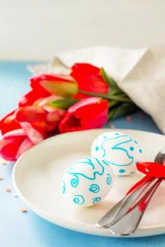 Easter table setting with tulips flowers and cutlery on stone table. Stock Photos
