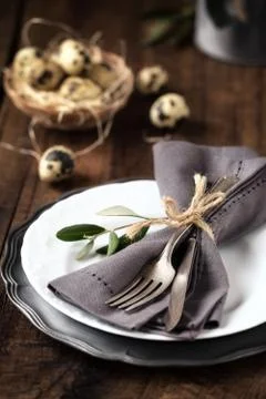 Easter table setting with vintage silverware with an olive branch Stock Photos