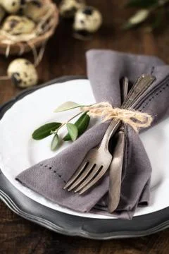 Easter table setting with vintage silverware with an olive branch Foto stock