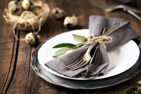 Easter table setting with vintage silverware with an olive branch on a plate Stock Photos