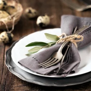 Easter table setting with vintage silverware with an olive branch Stock Photos