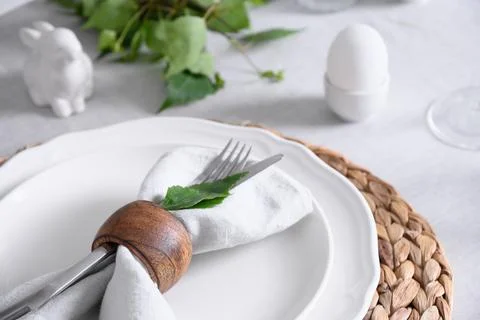 Easter table setting with white bunny and eggs, fresh flowers. Close up. Stock Photos