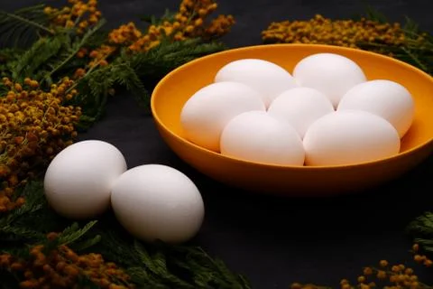 Easter table setting with white eggs with mimosa flower selective focus image Stock Photos