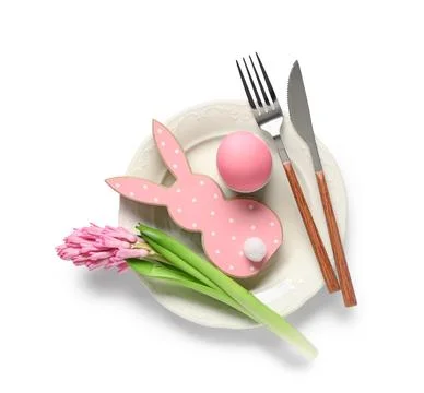 Easter table setting with wooden bunny, hyacinth flower and painted egg on wh Stock Photos