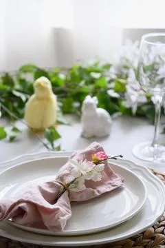 Easter table setting with yellow chick, fresh flowers and eggs. Close up. Stock Photos