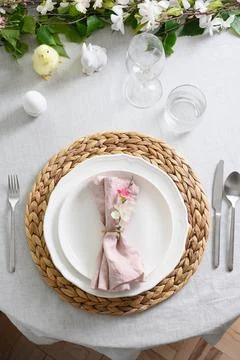 Easter table setting with yellow chick, fresh flowers and eggs. Close up. Stock Photos