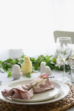 Easter table setting with yellow chick, fresh flowers and eggs. Close up. Stock Photos