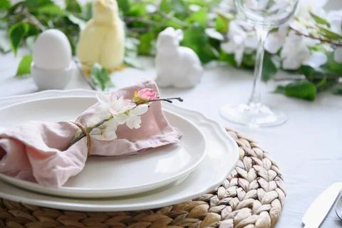Easter table setting with yellow chick,decorations, fresh flowers and eggs. Stock Photos