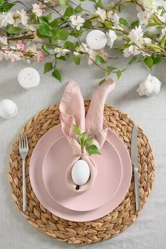 Easter table setting with yellow chick,decorations, fresh flowers and eggs. Stock Photos