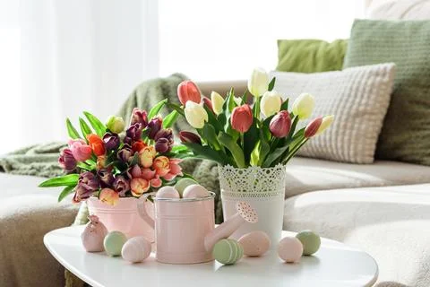 Easter Table with Tulip Bouquets, Eggs and Festive Decor. Cozy Spring Arran.. Stock Photos