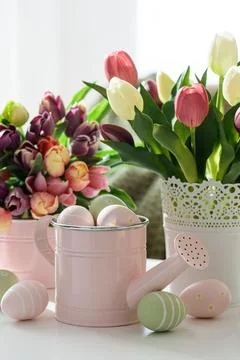 Easter Table with Tulip Bouquets, Eggs and Festive Decor. Cozy Spring Arran.. Stock Photos