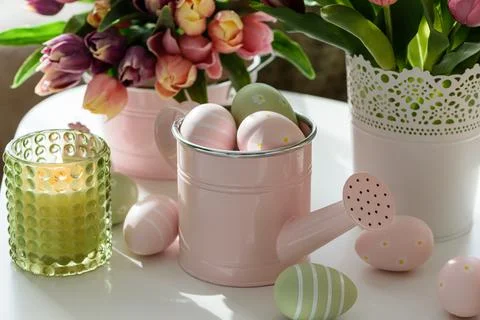 Easter Table with Tulip Bouquets, Eggs, Candles and Festive Decor. Cozy Spr.. Stock Photos