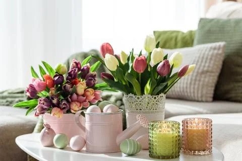 Easter Table with Tulip Bouquets, Eggs, Candles and Festive Decor. Cozy Spr.. Stock Photos