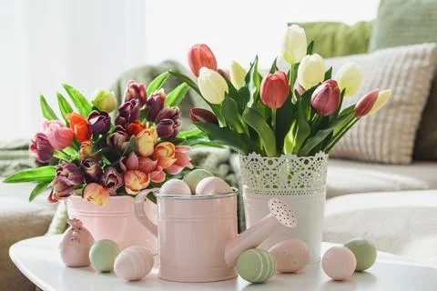 Easter Table with Tulip Bouquets, Eggs and Festive Decor. Cozy Spring Arran.. Stock Photos