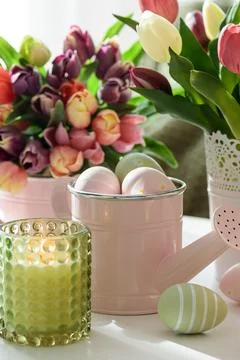 Easter Table with Tulip Bouquets, Eggs, Candles and Festive Decor. Cozy Spr.. Stock Photos