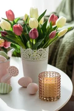 Easter Table with Tulip Bouquets, Eggs, Candles and Festive Decor. Cozy Spr.. Stock Photos