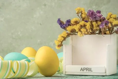 Easter template with colored eggs and calender over green Stock Photos