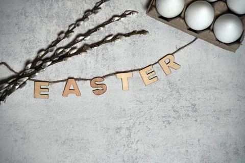 The easter text title with thread and twigs or pussy branches willow and eggs Stock Photos