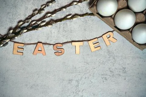 Easter text title with thread and twigs or pussy branches willow and eggs i.. Stock Photos