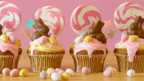 Easter theme candy land drip cupcakes decorated with chocolate bunnies. Stock Footage 105567941
