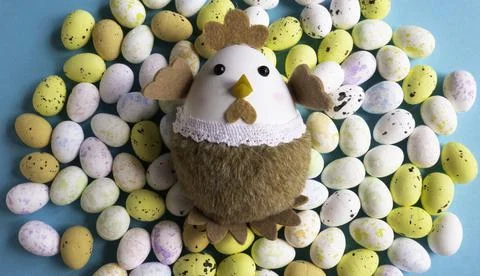 Easter theme - The toy chicken on eggs background. Stock Photos