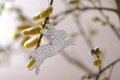 Easter time. Easter rabbit silver decoration on willow twigs Stock Photos