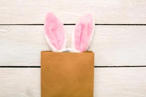 Easter traditional objects isolated on wooden background bunny ears in the bag Stock Photos