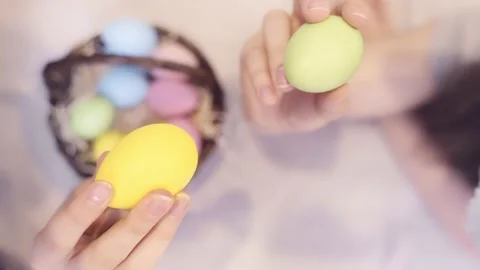 Easter traditions. Two teens with bunny ears playing with colorful eggs Stock Footage 236341725