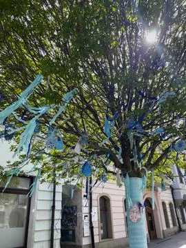 Easter tree with ribbons and egg decorations on streets with historical build Stock Photos
