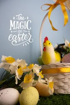 Easter vertical card featuring a white basket with a chicken, colorful eggs, Stock Photos