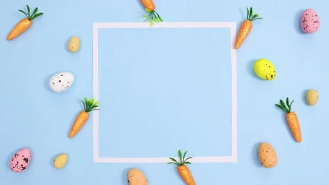 Easter vibrant eggs and carrots make pattern with copy space. Stop motion Stock Footage 149926893