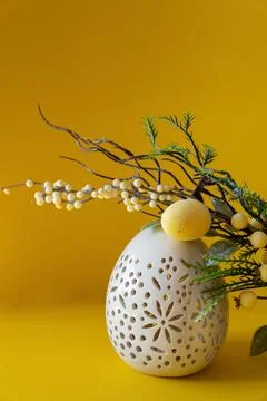 Easter white egg with branch and with Easter eggs on yellow background. Happy Stock Photos