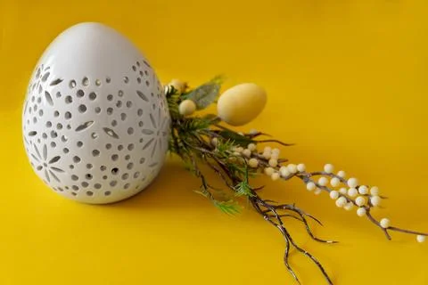 Easter white egg with branch and with Easter eggs on yellow background. Happy 스톡 사진