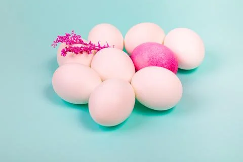 Easter. White eggs with red, on a uniform blue background. Stock Photos