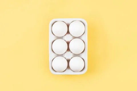 Easter white eggs on yellow background prepared for decoration. Minimal happy Stock Photos