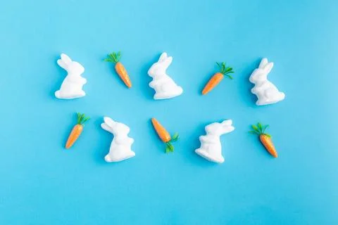 Easter white rabbits ready to paint carrots concept Stock Photos