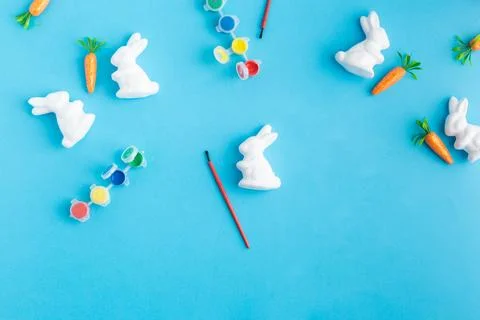 Easter white rabbits ready to paint carrots concept Stock Photos