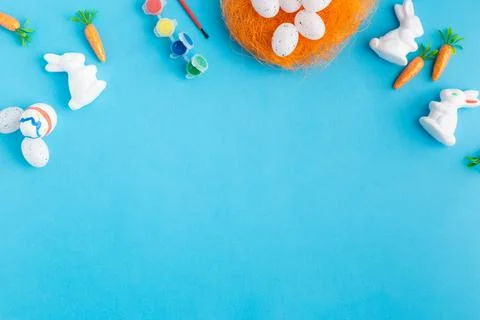 Easter white rabbits ready to paint carrots concept Stock Photos