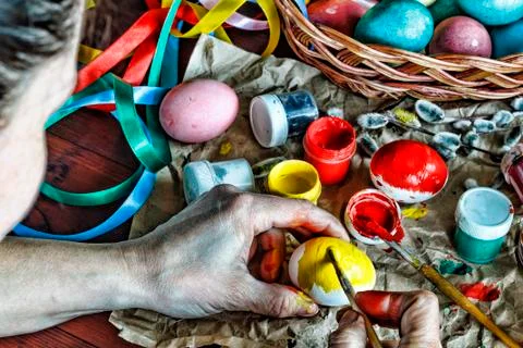 Easter. A woman is decorating Easter eggs at home. Photos