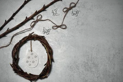 The easter wreath from branches vines with thread on grey background with c.. Stock Photos